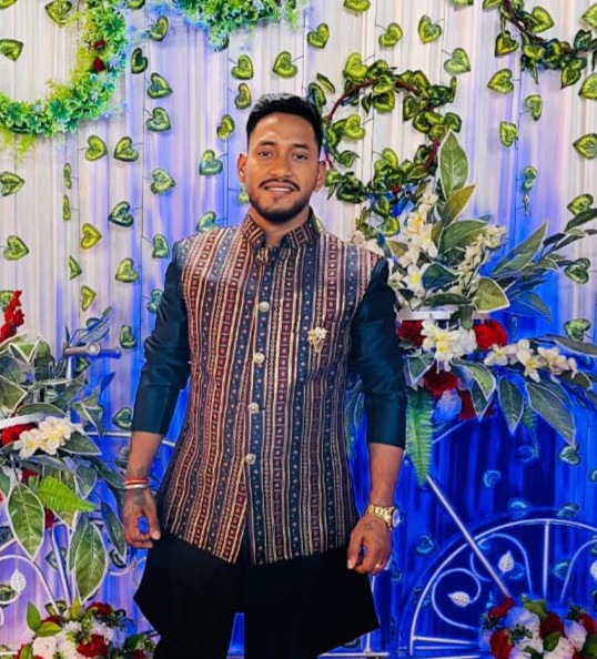 Indian operations manager in safety gear overseeing water bottling plant operations with modern equipment 